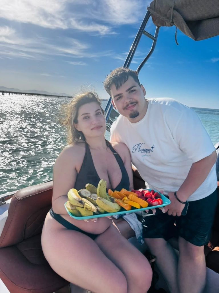 Guests with seasonal fruit on a boat trip